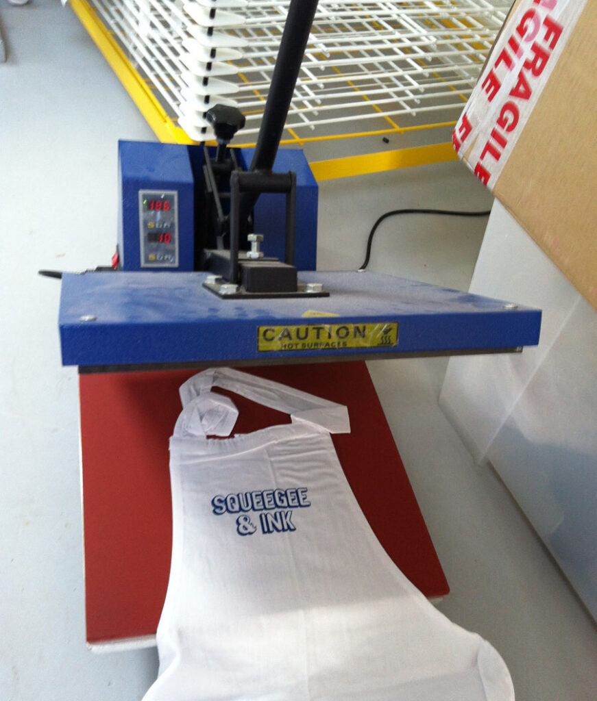 Heat press with apron